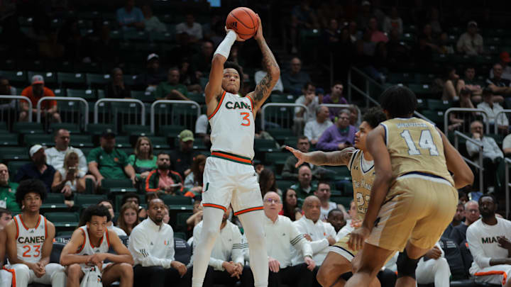 Dec 21, 2024; Coral Gables, Florida, USA; Miami Hurricanes guard Jalil Bethea (3) shoots the basketball over Mount St. Mary's Mountaineers guard Javon Ervin (23) during the second half at Watsco Center. Mandatory Credit: Sam Navarro-Imagn Images