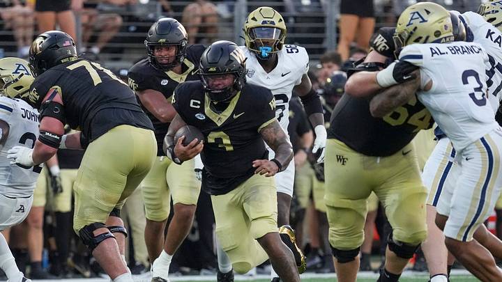 Sep 3, 2026; Winston-Salem, North Carolina, USA; Wake Forest Demon Deacons quarterback Gio Lopez (3) follows the blocks by offensive lineman Jack Hines (78) and offensive lineman Ryan Berger (64) during the first half at Allegacy Federal Credit Union Stadium. Mandatory Credit: Jim Dedmon-Imagn Images Sep 3, 2026; Winston-Salem, North Carolina, USA; Wake Forest Demon Deacons quarterback Gio Lopez (3) follows the blocks by offensive lineman Jack Hines (78) and offensive lineman Ryan Berger (64) during the first half at Allegacy Federal Credit Union Stadium. Mandatory Credit: Jim Dedmon-Imagn Images