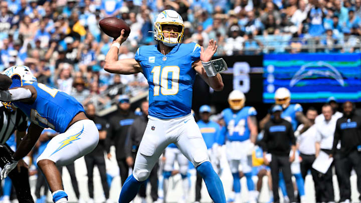 Sep 15, 2024; Charlotte, North Carolina, USA; Los Angeles Chargers quarterback Justin Herbert (10) throws a touchdown in the second quarter at Bank of America Stadium.