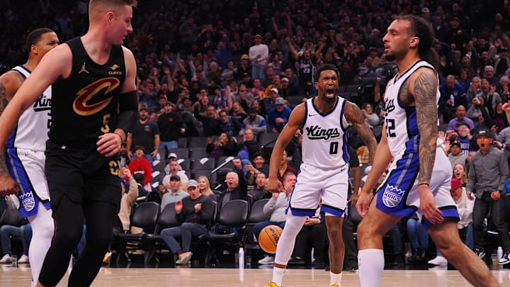Mar 19, 2025; Sacramento, California, USA; Sacramento Kings guard Malik Monk (0) reacts towards guard Devin Carter (22) after Carter’s dunk against Cleveland Cavaliers guard Sam Merrill (5) during the second quarter at Golden 1 Center. Mandatory Credit: Kelley L Cox-Imagn Images Mar 19, 2025; Sacramento, California, USA; Sacramento Kings guard Malik Monk (0) reacts towards guard Devin Carter (22) after Carter’s dunk against Cleveland Cavaliers guard Sam Merrill (5) during the second quarter at Golden 1 Center. Mandatory Credit: Kelley L Cox-Imagn Images