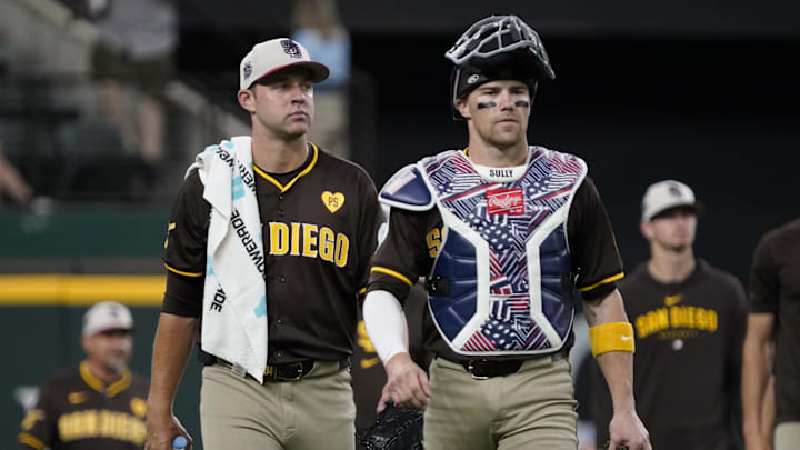 Padres pitcher Michael King (34) and catcher Brett Sullivan (29) walk in from the bullpen prior to a game against the Texas Rangers at Globe Life Field on July 4, 2024.