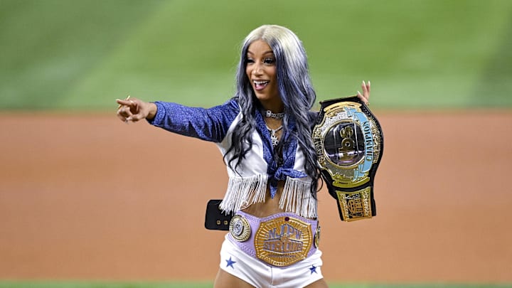Aug 15, 2024; Arlington, Texas, USA; Actress and professional wrestler Mercedes Mone Varnado points to the crowd before the game between the Texas Rangers and the Minnesota Twins at Globe Life Field. 