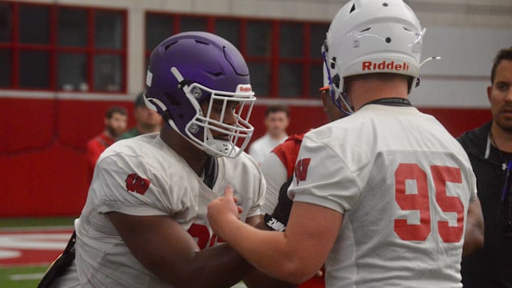 2027 defensive linemen Nehemiah Ombati, left, and Joshua Fasbender participate in a drill during Wisconsin's summer camp June 17.