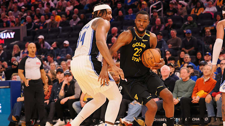 Feb 3, 2025; San Francisco, California, USA; Golden State Warriors forward Andrew Wiggins (22) drives in against Orlando Magic center Wendell Carter Jr (34) during the fourth quarter at Chase Center. Mandatory Credit: Kelley L Cox-Imagn Images