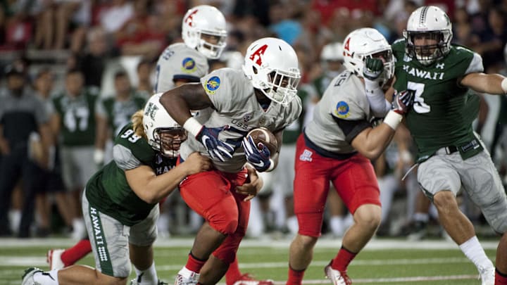 Sep 17, 2016; Tucson, AZ, USA; Arizona Wildcats running back Zach Green (34) runs the ball as he is tackled by Hawaii Warriors defensive lineman Zeno Choi (99) during the fourth quarter at Arizona Stadium. Mandatory Credit: Casey Sapio-Imagn Images