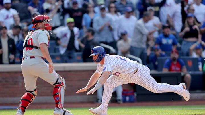 Apr 23, 2025; New York City, New York, USA; New York Mets first baseman Pete Alonso (20) scores the game winning run against Philadelphia Phillies catcher J.T. Realmuto (10) on a walkoff single by designated hitter Starling Marte (not pictured) during the tenth inning at Citi Field. Mandatory Credit: Brad Penner-Imagn Images