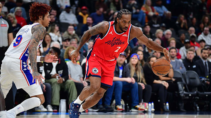 Feb 2, 2026; Inglewood, California, USA; Los Angeles Clippers forward Kawhi Leonard (2) moves the ball against Philadelphia 76ers guard Kelly Oubre Jr. (9) during the first half at Intuit Dome. Mandatory Credit: Gary A. Vasquez-Imagn Images