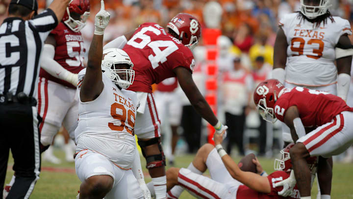 Texas defensive lineman Keondre Coburn (99) celebrates as Oklahoma quarterback Davis Beville (11) is