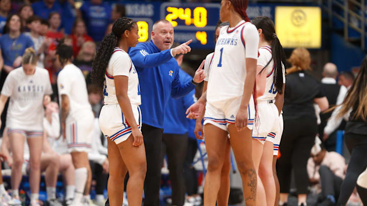 Kansas coach Bradon Schneider gathers his players during the second half of the Sunflower Showdown