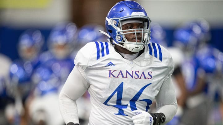 Kansas junior defensive end Davion Westmoreland (46) practices with teammates Friday evening