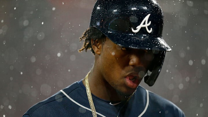 Atlanta Braves left fielder Ronald Acuna Jr. (13) walks for the dugout as the grounds crew covers