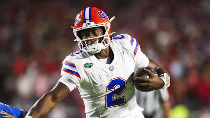 Nov 15, 2025; Oxford, Mississippi, USA; Florida Gators quarterback DJ Lagway (2) stiff-arms away from a tackle attempt against the Mississippi Rebels at Vaught-Hemingway Stadium. Mandatory Credit: Petre Thomas-Imagn Images