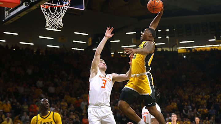 Iowa   s Tony Perkins (11) attempts a dunk against Illinois Sunday, March 10, 2024 at Carver-Hawkeye