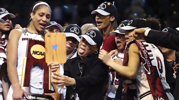 South Carolina basketball coach Dawn Staley posing with A'ja Wilson and the 2016-2017 National Championship trophy