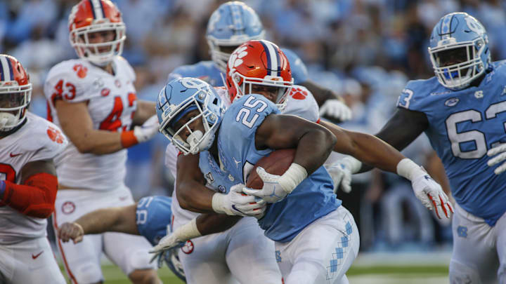 Sep 28, 2019; Chapel Hill, NC, USA; North Carolina Tar Heels running back Javonte Williams (25) fights for yards against the Clemson Tigers in the second half at Kenan Memorial Stadium. The Clemson Tigers won 21-20. Mandatory Credit: Nell Redmond-Imagn Images
