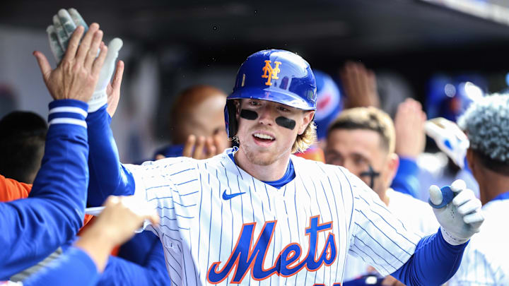Mar 30, 2024; New York City, New York, USA;  New York Mets third baseman Brett Baty (22) is greeted in the dugout after hitting a pinch hit 3 run home run in the eighth inning against the Milwaukee Brewers at Citi Field. Mandatory Credit: Wendell Cruz-Imagn Images