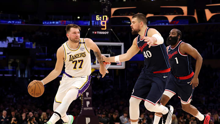 Mar 2, 2025; Los Angeles, California, USA; Los Angeles Lakers guard Luka Doncic (77) dribbles against LA Clippers center Ivica Zubac (40) and guard James Harden (1) during the second quarter at Crypto.com Arena. Mandatory Credit: Jason Parkhurst-Imagn Images Mar 2, 2025; Los Angeles, California, USA; Los Angeles Lakers guard Luka Doncic (77) dribbles against LA Clippers center Ivica Zubac (40) and guard James Harden (1) during the second quarter at Crypto.com Arena. Mandatory Credit: Jason Parkhurst-Imagn Images
