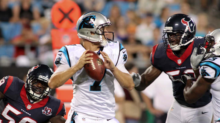 Carolina Panthers quarterback Jimmy Clausen gets pressured by Houston Texans linebacker Whitney Mercilus.