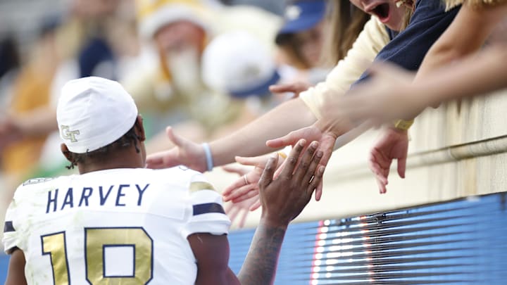 Nov 4, 2023; Charlottesville, Virginia, USA; Georgia Tech Yellow Jackets defensive back Ahmari Harvey (18) shakes hands with fans in the stands after defeating the Virginia Cavaliers at Scott Stadium. Mandatory Credit: Amber Searls-Imagn Images