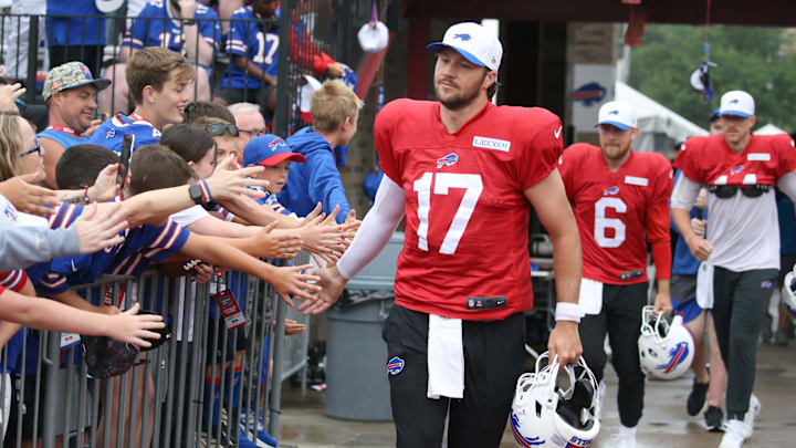 Josh Allen leads the QBs onto the field, high-fiving fans as they go, during day seven of Buffalo Bills training camp. Josh Allen leads the QBs onto the field, high-fiving fans as they go, during day seven of Buffalo Bills training camp.