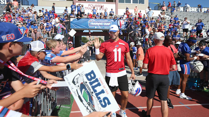 Bills quarterback Mitch Trubisky high-fives fans as he takes the field during the opening day of Buffalo Bills training camp.