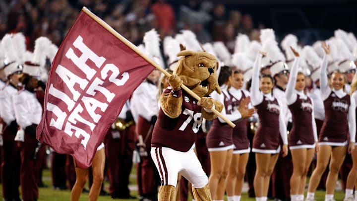 Nov 23, 2023; Starkville, Mississippi, USA; Mississippi State Bulldogs mascot Bully waves a flag during player introduction prior to the game against the Mississippi Rebels at Davis Wade Stadium at Scott Field. Mandatory Credit: Petre Thomas-Imagn Images Nov 23, 2023; Starkville, Mississippi, USA; Mississippi State Bulldogs mascot Bully waves a flag during player introduction prior to the game against the Mississippi Rebels at Davis Wade Stadium at Scott Field. Mandatory Credit: Petre Thomas-Imagn Images