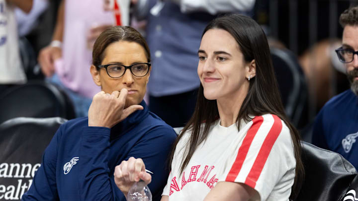 Aug 7, 2025; Phoenix, Arizona, USA; Indiana Fever injured guard Caitlin Clark (right) with head coach Stephanie White against the Phoenix Mercury during an WNBA game at PHX Arena. Mandatory Credit: Mark J. Rebilas-Imagn Images