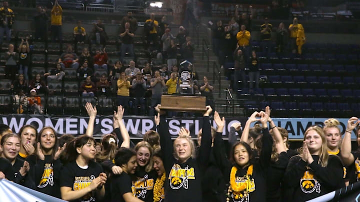 Iowa's women's wrestling team celebrates winning the team title on Saturday, March 9, 2024, at the NCWWCs at Alliant Energy PowerHouse in Cedar Rapids, Iowa. Iowa's women's wrestling team celebrates winning the team title on Saturday, March 9, 2024, at the NCWWCs at Alliant Energy PowerHouse in Cedar Rapids, Iowa.