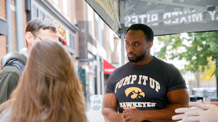 Hawkeye alum and WWE star Ettore “Big E” Ewen helps hand out chips and queso during Pancheros’ Hawkeye Homecoming Happy Hour Thursday, Oct. 24, 2024 in Iowa City, Iowa.