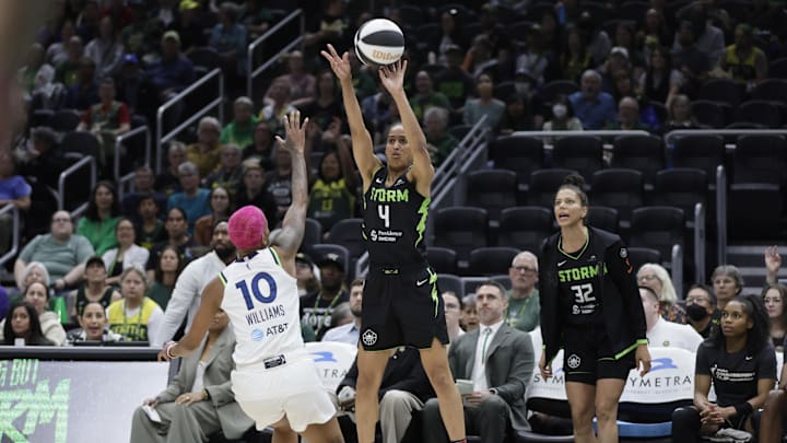 Jun 11, 2025; Seattle, Washington, USA; Seattle Storm guard Skylar Diggins (4) makes a three point shot with Minnesota Lynx guard Courtney Williams (10) defending during the first half at Climate Pledge Arena. 
