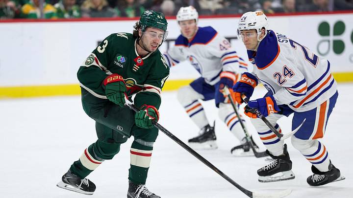Dec 20, 2025; Saint Paul, Minnesota, USA; Minnesota Wild defenseman Quinn Hughes (43) reaches for the puck as Edmonton Oilers defenseman Spencer Stastney (24) defends during the first period at Grand Casino Arena. Mandatory Credit: Matt Krohn-Imagn Images Dec 20, 2025; Saint Paul, Minnesota, USA; Minnesota Wild defenseman Quinn Hughes (43) reaches for the puck as Edmonton Oilers defenseman Spencer Stastney (24) defends during the first period at Grand Casino Arena. Mandatory Credit: Matt Krohn-Imagn Images