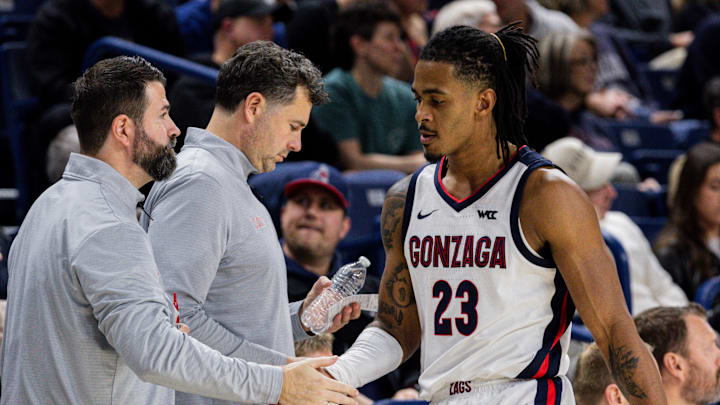 Gonzaga assistant coaches Jorge Sanz (left), Brian Michaelson (middle) and guard Adam Miller (23).