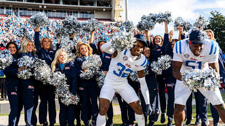 Ole Miss defensive back Chris Graves Jr. (32) and defensive lineman Zxavian Harris (51) celebrate with Ole Miss cheerleaders during a college football game between Mississippi State and Ole Miss at Davis Wade Stadium in Starkville, Miss., on Friday, Nov. 28, 2025. Ole Miss defeated Mississippi State 38-19 in the Egg Bowl. Ole Miss defensive back Chris Graves Jr. (32) and defensive lineman Zxavian Harris (51) celebrate with Ole Miss cheerleaders during a college football game between Mississippi State and Ole Miss at Davis Wade Stadium in Starkville, Miss., on Friday, Nov. 28, 2025. Ole Miss defeated Mississippi State 38-19 in the Egg Bowl.