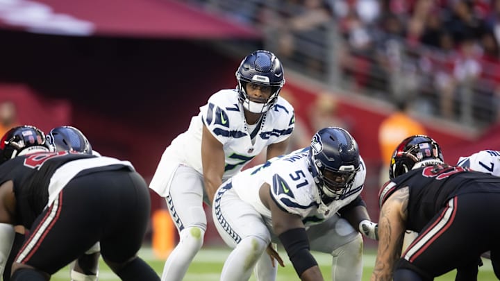 Dec 8, 2024; Glendale, Arizona, USA; Seattle Seahawks center Olu Oluwatimi (51) prepares to snap the ball to quarterback Geno Smith (7) against the Arizona Cardinals at State Farm Stadium. 