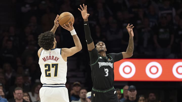 Apr 30, 2026; Minneapolis, Minnesota, USA; Denver Nuggets guard Jamal Murray (27) shoots the ball over Minnesota Timberwolves forward Jaden McDaniels (3) in the first half during game six of the first round of the 2026 NBA Playoffs at Target Center. Mandatory Credit: Jesse Johnson-Imagn Images