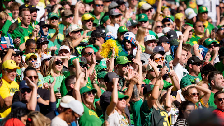 Oregon fans cheer for the Ducks against Texas Tech in the Orange Bowl at Hard Rock Stadium in Miami. Oregon fans cheer for the Ducks against Texas Tech in the Orange Bowl at Hard Rock Stadium in Miami.