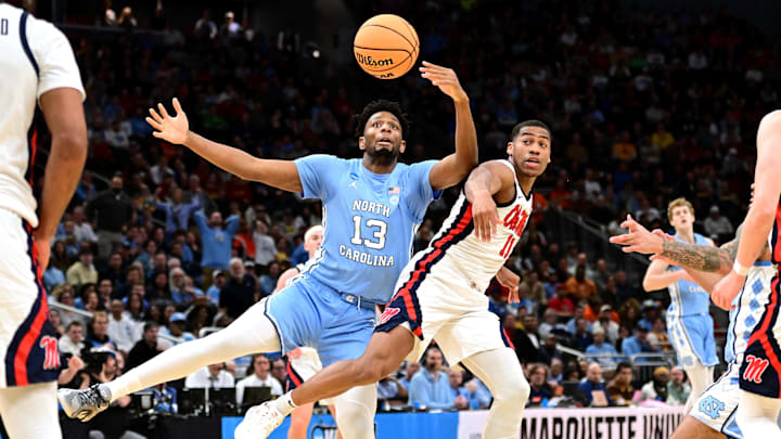 North Carolina Tar Heels forward Jalen Washington (13) and Mississippi Rebels guard Matthew Murrell (11) chase a loose ball during the first half of a first round NCAA men’s tournament game at Fiserv Forum.