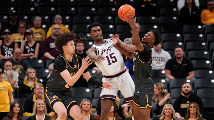 Missouri guard Anthony Robinson II tries to steal a pass from Texas A&M.