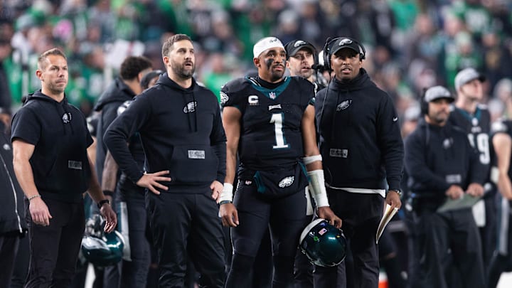 Dec 25, 2023; Philadelphia, Pennsylvania, USA; Philadelphia Eagles head coach Nick Sirianni (L) and quarterback Jalen Hurts (1) and offensive coordinator Brian Johnson (R) look on during the second quarter against the New York Giants at Lincoln Financial Field. Mandatory Credit: Bill Streicher-USA TODAY Sports