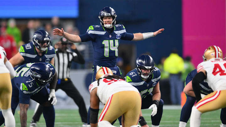 Jan 17, 2026; Seattle, WA, USA; Seattle Seahawks quarterback Sam Darnold (14) calls a play at the line of scrimmage against the San Francisco 49ers during the first half in an NFC Divisional Round game at Lumen Field. Mandatory Credit: Steven Bisig-Imagn Images