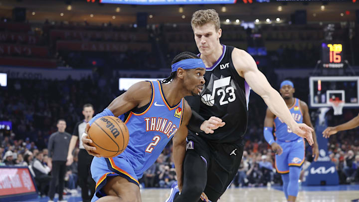 Jan 22, 2025; Oklahoma City, Oklahoma, USA; Oklahoma City Thunder guard Shai Gilgeous-Alexander (2) drives around Utah Jazz forward Lauri Markkanen (23) during the first quarter at Paycom Center. Mandatory Credit: Alonzo Adams-Imagn Images