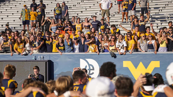 Sep 21, 2024; Morgantown, West Virginia, USA; West Virginia Mountaineers fans celebrate after defeating the Kansas Jayhawks at Mountaineer Field at Milan Puskar Stadium. Mandatory Credit: Ben Queen-Imagn Images