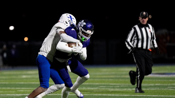 St. Xavier Bombers wide receiver Alex Walker (9) tackles Middletown Middies player Jordan Vann (4) in the first quarter of the OHSAA State Semi-Final football game at Welcome Stadium in Dayton on Nov. 28, 2025.