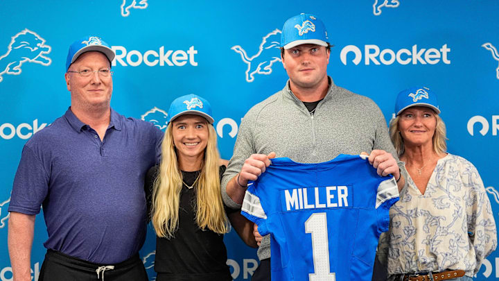 Detroit Lions first round draft Blake Miller, center, poses for a photo with his father Chris Miller, left, girlfriend Kylie Jicha, center left, and mother Karen Miller at his introductory press conference at Meijer Performance Center in Allen Park on Friday, April 24, 2026.