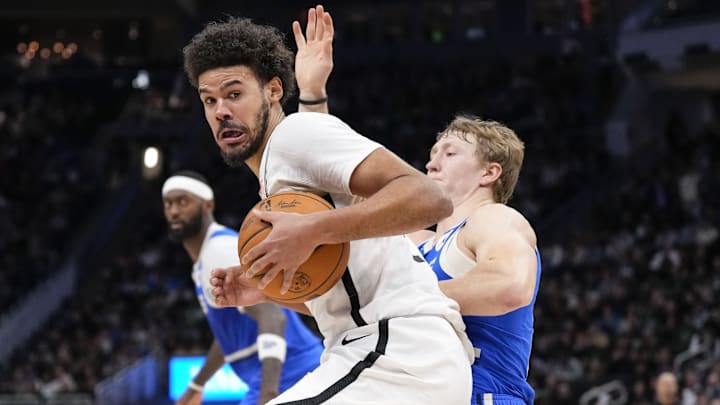 Dec 26, 2024; Milwaukee, Wisconsin, USA;  Brooklyn Nets forward Cameron Johnson (2) spins towards the basket around Milwaukee Bucks guard AJ Green (20) during the fourth quarter at Fiserv Forum. Mandatory Credit: Jeff Hanisch-Imagn Images