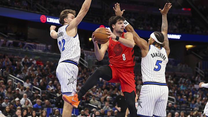 Nov 10, 2025; Orlando, Florida, USA; Portland Trail Blazers forward Deni Avdija (8) passes the ball past Orlando Magic forward Franz Wagner (22) and forward Paolo Banchero (5) in the first quarter at Kia Center. Mandatory Credit: Nathan Ray Seebeck-Imagn Images Nov 10, 2025; Orlando, Florida, USA; Portland Trail Blazers forward Deni Avdija (8) passes the ball past Orlando Magic forward Franz Wagner (22) and forward Paolo Banchero (5) in the first quarter at Kia Center. Mandatory Credit: Nathan Ray Seebeck-Imagn Images