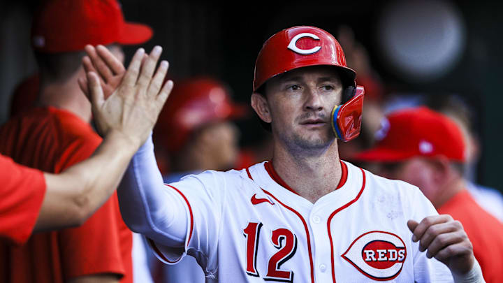 Aug 13, 2025; Cincinnati, Ohio, USA; Cincinnati Reds outfielder Austin Hays (12) high fives teammates after scoring on a RBI double hit by outfielder Noelvi Marte (not pictured) in the fourth inning against the Philadelphia Phillies at Great American Ball Park. Mandatory Credit: Katie Stratman-Imagn Images