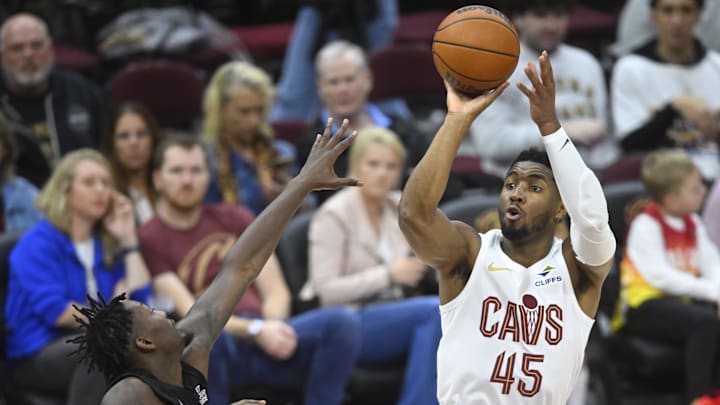 Nov 9, 2024; Cleveland, Ohio, USA; Cleveland Cavaliers guard Donovan Mitchell (45) shoots beside Brooklyn Nets forward Dorian Finney-Smith (28) in the third quarter at Rocket Mortgage FieldHouse. Mandatory Credit: David Richard-Imagn Images