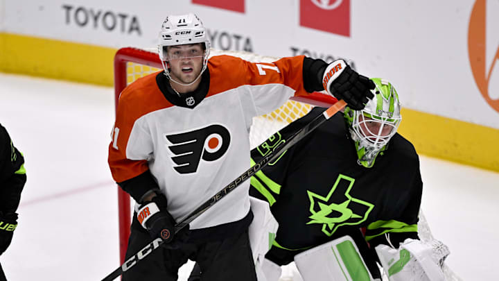Mar 22, 2025; Dallas, Texas, USA; Philadelphia Flyers right wing Tyson Foerster (71) looks for the puck in front of Dallas Stars goaltender Jake Oettinger (29) during the third period at the American Airlines Center. Mandatory Credit: Jerome Miron-Imagn Images