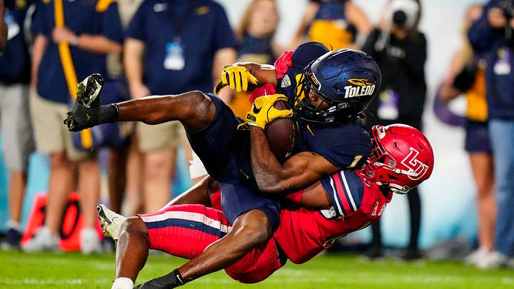 Dec 20, 2022; Boca Raton, Florida, USA; Liberty Flames safety Brylan Green (15) tackles Toledo Rockets wide receiver Jerjuan Newton (1) during the second half in the 2022 Boca Raton Bowl at FAU Stadium. Mandatory Credit: Rich Storry-USA TODAY Sports Dec 20, 2022; Boca Raton, Florida, USA; Liberty Flames safety Brylan Green (15) tackles Toledo Rockets wide receiver Jerjuan Newton (1) during the second half in the 2022 Boca Raton Bowl at FAU Stadium. Mandatory Credit: Rich Storry-USA TODAY Sports